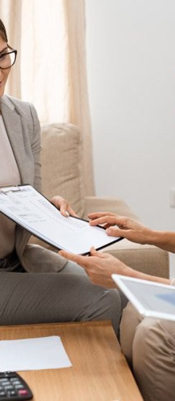 Two women reviewing printed reports